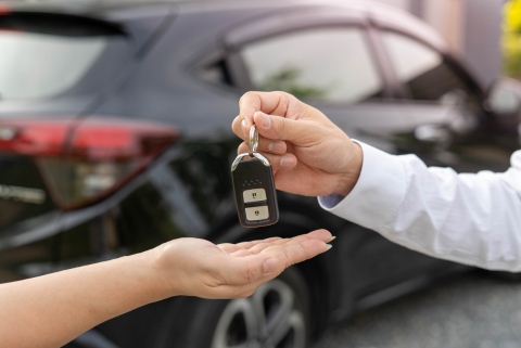 Person handing another person keys